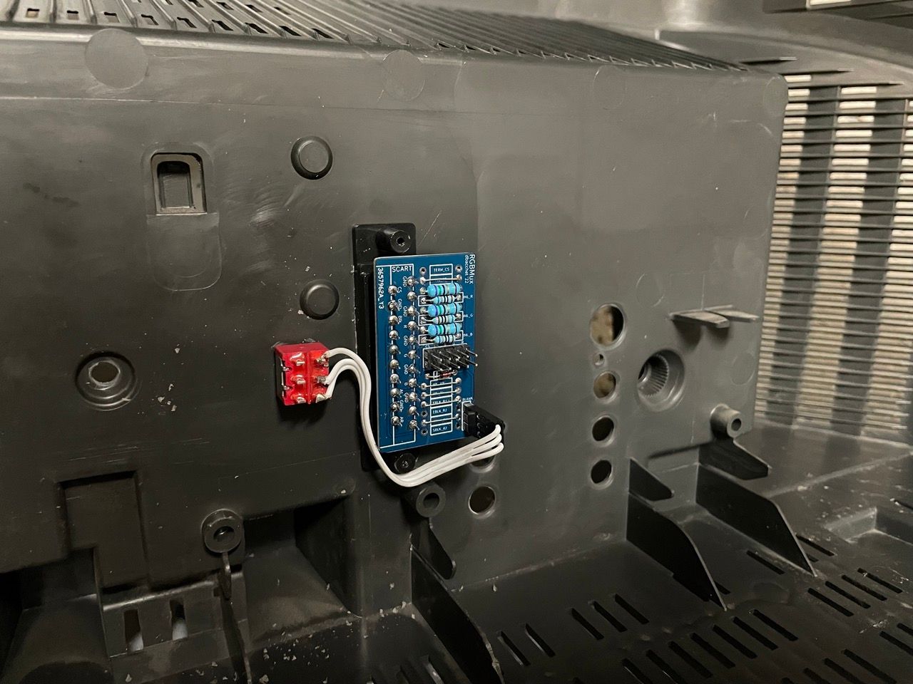 KV-24FV12 - The board with the SCART connector can be installed on the back plastic cover, between the RCA connectors and...